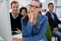 Shes leading her team with confidence. Smiling businesswoman looking at the camera with her coworkers in the background. Royalty Free Stock Photo