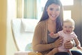 Shes a lovable little handful. Portrait of a mother holding her baby girl at home.