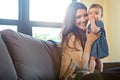 Shes a lovely little handful. Portrait of a mother holding her baby girl at home.