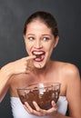 Shes a lover of chocolate. Studio shot of an attractive young woman being tempted by something sweet.