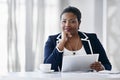 Shes making her own success. Portrait of a young businesswoman using a digital tablet while sitting at a desk in an Royalty Free Stock Photo