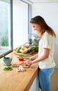 Shes a master chef. an attractive young woman chopping vegetables in a kitchen.