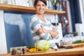 Shes mastered the art of cooking. Portrait of an attractive woman standing behind a kitchen counter filled with
