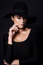 Shes a mystery youd like to unravel. Portrait of an attractive woman wearing a black hat.