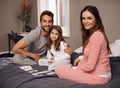 Shes our little diamond. a young family playing cards together at home. Royalty Free Stock Photo