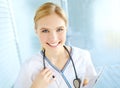 Shes prepared to be the best. Portrait of a pretty nurse with her stethoscope holding a medical file with copyspace. Royalty Free Stock Photo