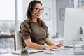 Shes a problem solver. an attractive young female call center agent working at her desk in the office.