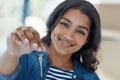 Shes the proud new owner of this house. Portrait of a happy young woman holding up the keys to her new home. Royalty Free Stock Photo