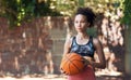 Shes ready for the next game. an attractive young female athlete standing on the basketball court.