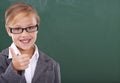 Shes ready to learn. Portrait of a little girl pretending to be a teacher and showing a thumbs up. Royalty Free Stock Photo