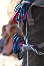 Shes ready to make the climb. the ccarabiners attached to a female rock climber.