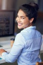 Shes a real go-getter. Portrait of a young businesswoman working on her office computer.