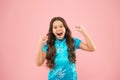 Shes a real winner. Little girl shout and make winner gesture on pink background. Happy small winner active gesturing in