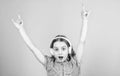 Shes a rock star. Little kid showing horn hand gesture like a hard rock or heavy metal fan. Cute small child listening Royalty Free Stock Photo