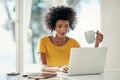 Shes a self-starter. an attractive young woman working on her laptop at home. Royalty Free Stock Photo