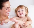 Shes ticklish. A cute little girl being tickled by her mother.