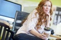 Shes on to a good idea. Portrait of an attractive ginger woman smiling and thinking at her desk while on a break and Royalty Free Stock Photo