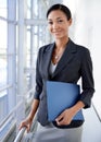 Shes on top of all the admin. A businesswoman holding a file while looking at the camera. Royalty Free Stock Photo