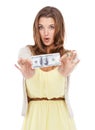 Shes a wealthy young woman. Studio portrait of a cute young woman holding out a dollar bill.