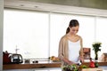 Shes a whizz in the kitchen. an attractive young woman preparing a salad at home in the kitchen.