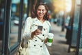 Shes a woman around town. a happy young woman going for a walk around the city.