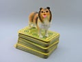 Shetland Sheepdog figurine and a deck of cards. Royalty Free Stock Photo