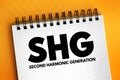 SHG - Second Harmonic Generation acronym text on notepad, abbreviation concept background Royalty Free Stock Photo