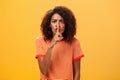 Shh do not disturb. Portrait of serious-looking bossy and displeased cute african american girl with afro hairstyle Royalty Free Stock Photo