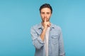 Shh, keep quiet, this is confidential! Portrait of handsome man in worker denim shirt showing silence gesture Royalty Free Stock Photo