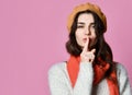 Pretty charming young woman having secret while holding finger on lips and showing silence sign Royalty Free Stock Photo