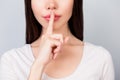 Shhh! Close up portrait of half face of young woman with finger Royalty Free Stock Photo