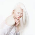 Shhh gesture. Albino female with white skin and white long hair. Photo face on a light background. Blonde girl Royalty Free Stock Photo