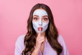 Shhh, keep it in secret. Photo portrait of pretty young woman with hydrating mask on face keeping put near pouted lips Royalty Free Stock Photo