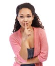 Shhhh its our secret. Portrait of young woman holding finger in front of her lips against a white background. Royalty Free Stock Photo
