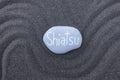 Shiatsu word carved on a stone over black volcanic sand Royalty Free Stock Photo