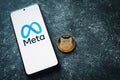 Shiba Inu crypto and Meta logo on phone