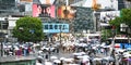 Shibuya Scramble Crossing. Tokyo. People with umbrellas crossing the street. Colorful advertising signs on buildings.