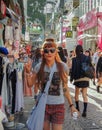 Kawaii stylish redhead young woman posing for photo at the famous takeshita street in tokyo