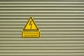 Shield Attention High voltage Danger to life on metal door with crosswise metal lamellas