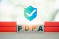 Shield with checkmark icon above wood block text of PDPA. Personal Data Protection Act or PDPA