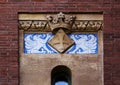 Shield with cross protected by winged dragons