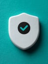 Shield icon with a checkmark on a teal background, symbolizing security. Royalty Free Stock Photo