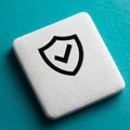 Shield icon with checkmark on white tile, teal background Royalty Free Stock Photo