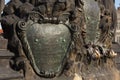 Shield metal, coat of arms ancient inscriptions. element of bronze ornaments sculpture of Charles Bridge. Czech Republic