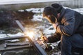 Shielded metal arc welding. Worker welding metal with electrodes, wearing protective helmet and gloves. Close up of electrode Royalty Free Stock Photo