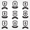 Shields icon set. Different shield shapes with fleur-de-lis symbol and stylish ribbon. Heraldic royal design. Vector illustration Royalty Free Stock Photo