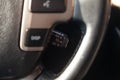 The shift lever to set the automatic cruise control speed inside the car close-up located near the steering wheel in black with Royalty Free Stock Photo