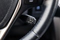 The shift lever to set the automatic cruise control speed inside the car close-up located near the steering wheel in black with Royalty Free Stock Photo