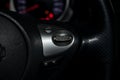 The shift lever to set the automatic cruise control speed inside the car close-up located on the steering wheel in black with Royalty Free Stock Photo