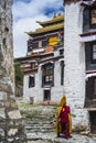 Tibetan Buddhist monk walks in street of Tashilhunpo Monastery . Shigatse , Tibet Royalty Free Stock Photo